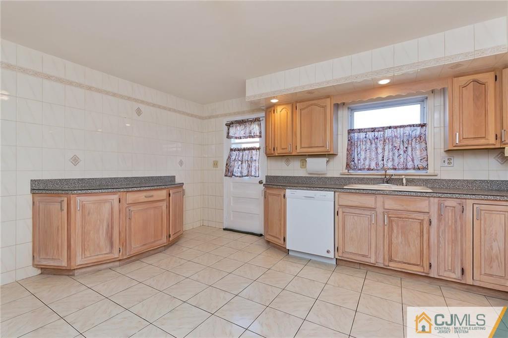 1591 Ridgeway Street Union, NJ 07083 - Photo 10 of 24 a kitchen with granite countertop white cabinets sink and stainless steel appliances