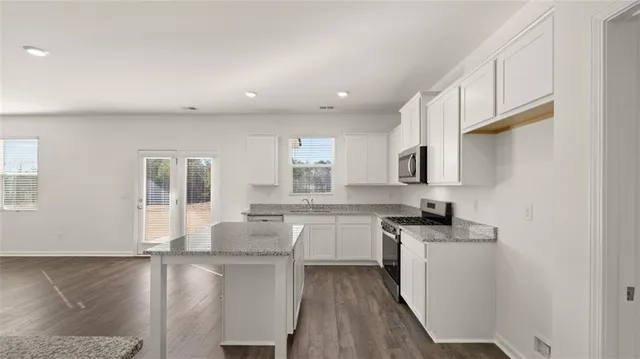 a kitchen with sink stove and cabinets