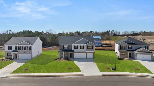 an aerial view of a house with a yard