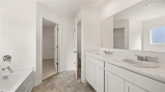 a bathroom with a double vanity sink and mirror