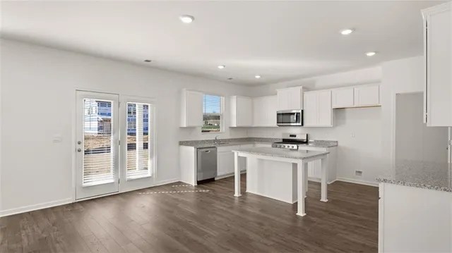 a kitchen with a sink cabinets and wooden floor