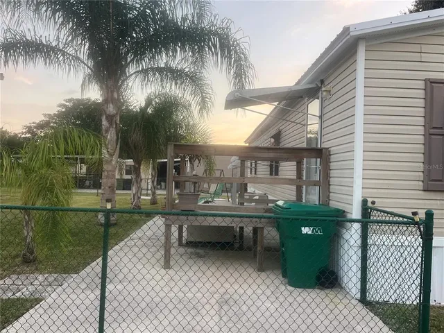 a backyard of a house with barbeque oven and outdoor seating