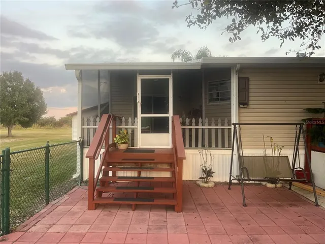 a front view of a house with outdoor seating