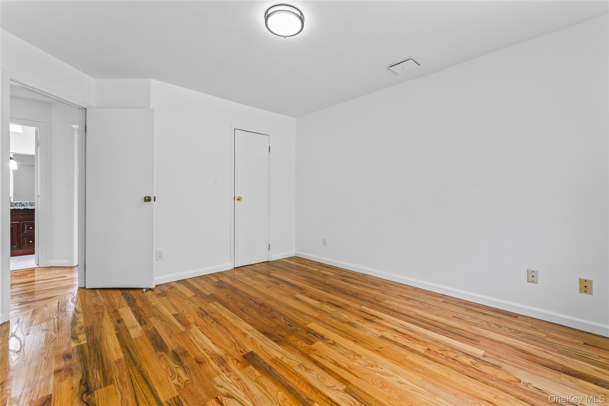 126 Bagatelle Road Melville, NY 11747 - Photo 27 of 50 a view of empty room with wooden floor
