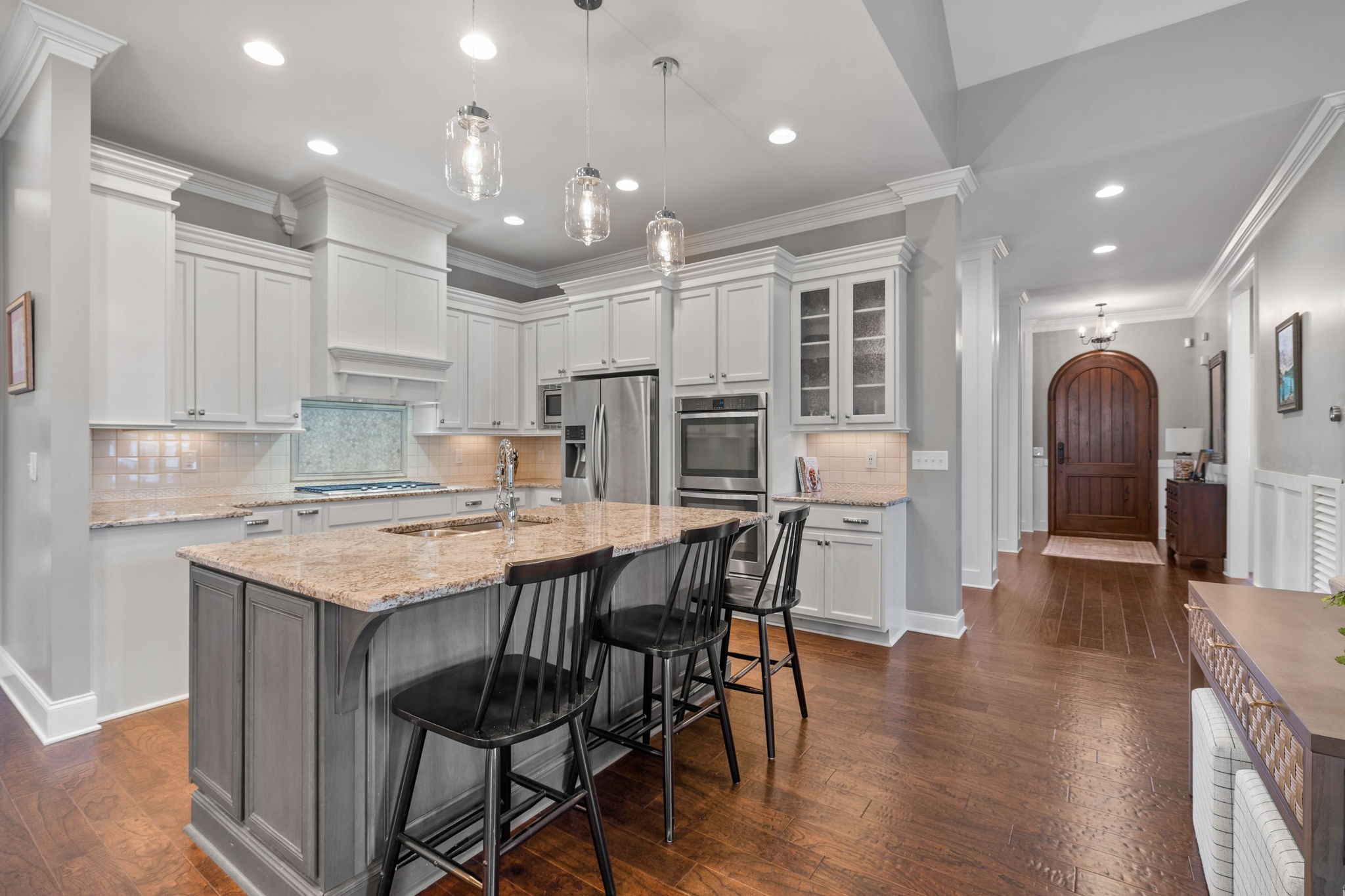 312 Cedar Street Lebanon, TN 37087 - Photo 12 of 69 a kitchen with stainless steel appliances granite countertop a stove top oven a refrigerator a sink and a dining table with wooden floor