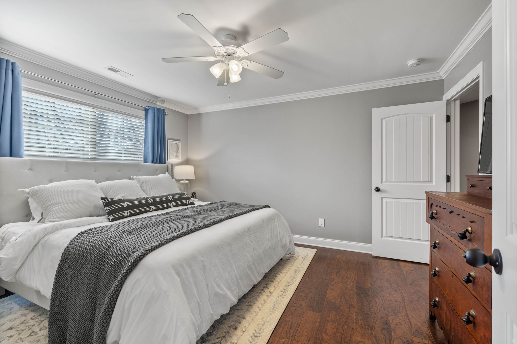 312 Cedar Street Lebanon, TN 37087 - Photo 37 of 69 a bedroom with a large bed and a chandelier