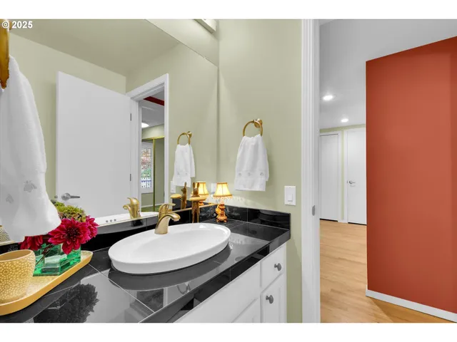 a bathroom with a granite countertop sink a toilet and a mirror