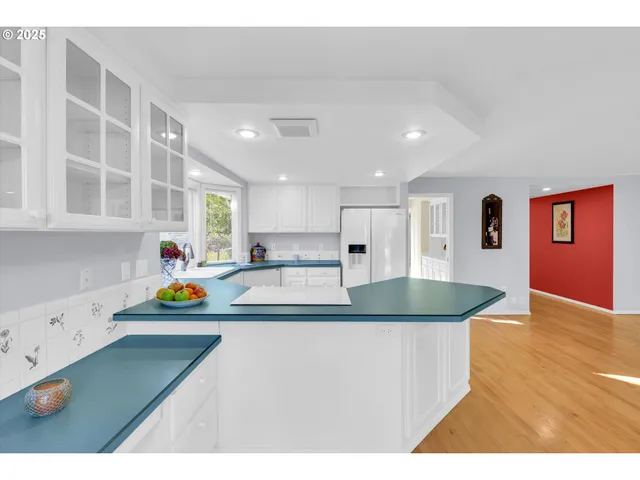 a kitchen with stainless steel appliances granite countertop a sink a stove and a refrigerator