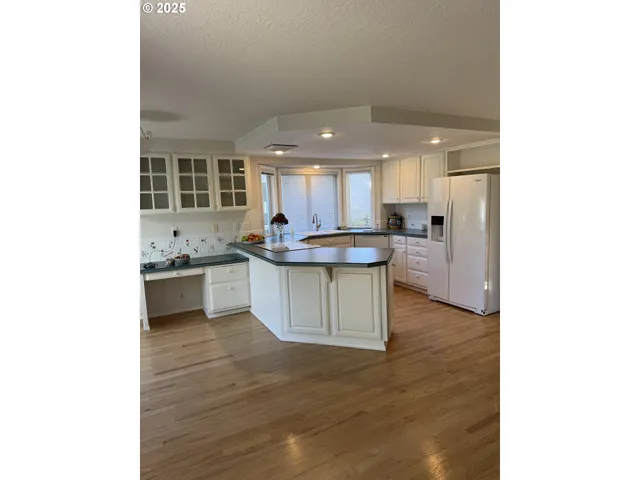 a kitchen with stainless steel appliances granite countertop a sink and cabinets