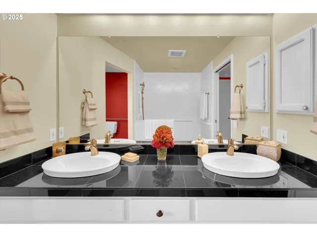 a bathroom with a sink double vanity and a mirror