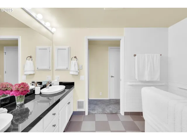 a bathroom with a sink vanity and a mirror