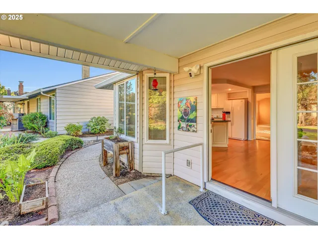 a view of a porch with a table and chairs