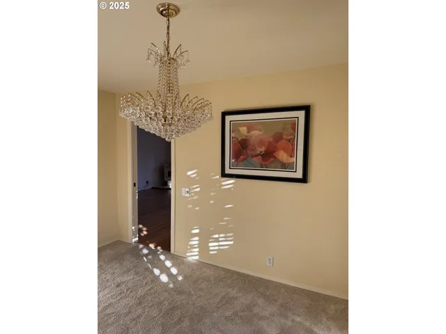 a view of a hallway with chandelier
