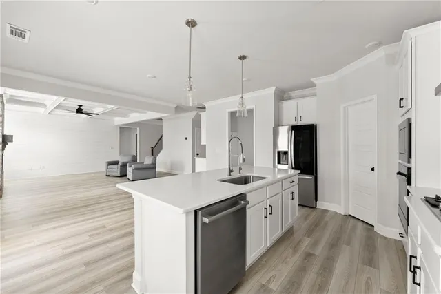 a kitchen with a sink stove and refrigerator