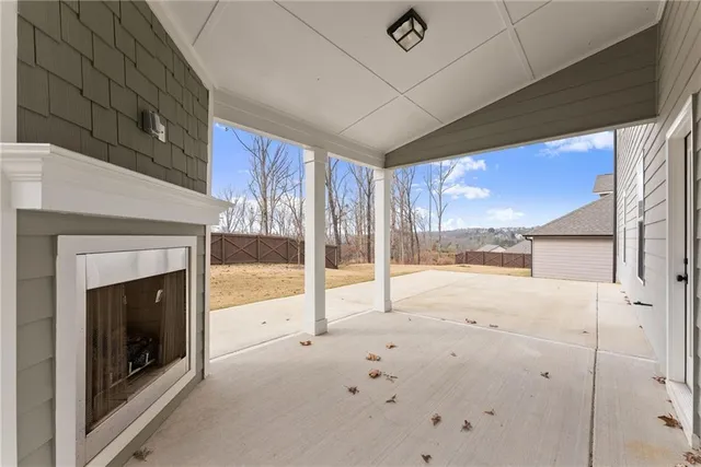 a view of an empty room with a fireplace