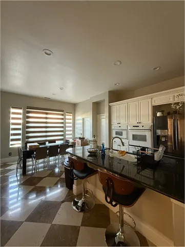 a living room with lots of furniture and floor to ceiling window