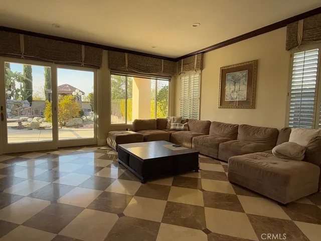 a living room with furniture and large windows