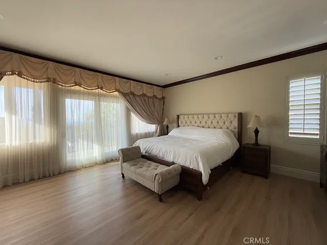 a large bed sitting in a room next to a window