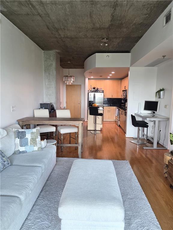 250 Pharr Road Northeast, Unit 1816 Atlanta, GA 30305 - Photo 13 of 36 a living room with stainless steel appliances dining table furniture and a large window