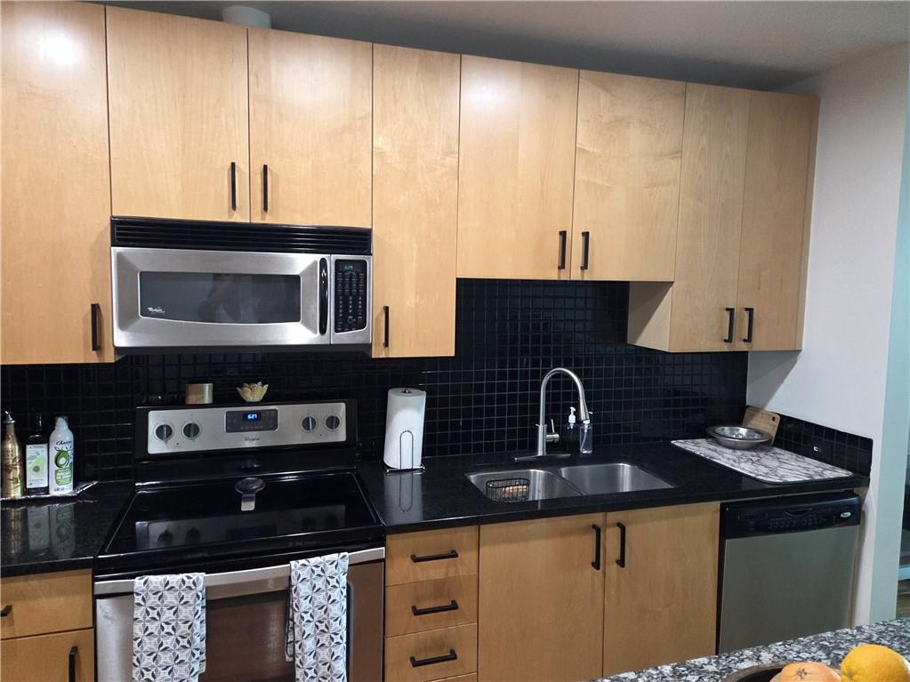 250 Pharr Road Northeast, Unit 1816 Atlanta, GA 30305 - Photo 15 of 36 a kitchen with a sink and a stove