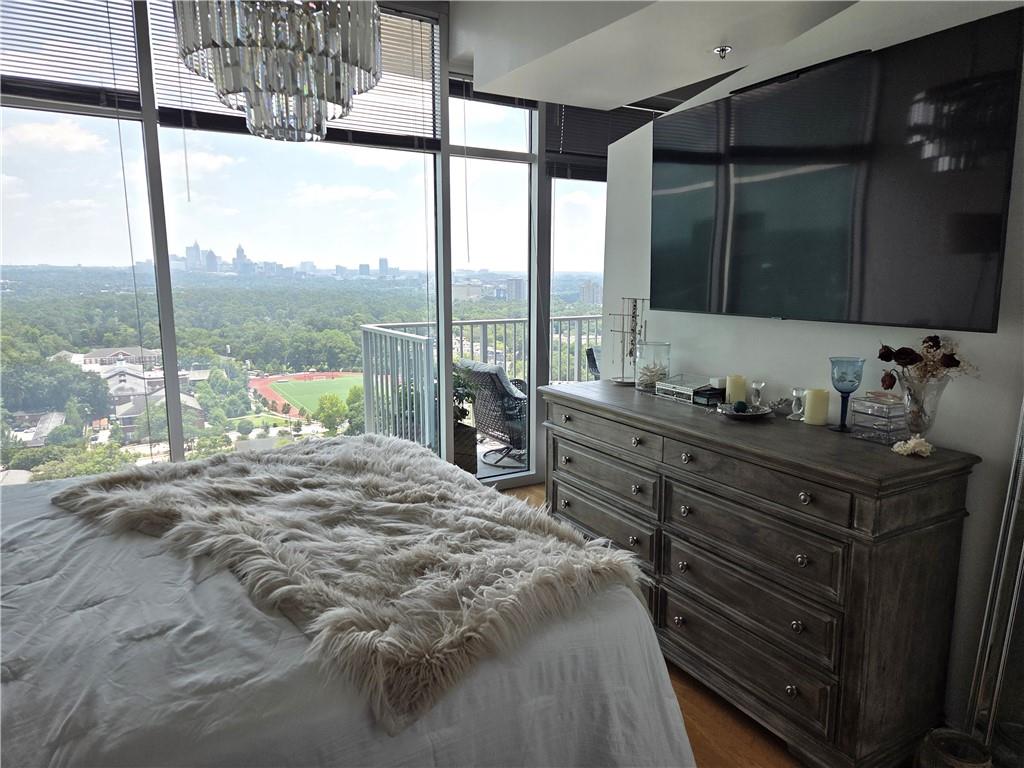 250 Pharr Road Northeast, Unit 1816 Atlanta, GA 30305 - Photo 17 of 36 a bed sitting in a bedroom next to a window