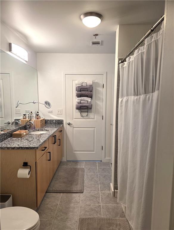 250 Pharr Road Northeast, Unit 1816 Atlanta, GA 30305 - Photo 21 of 36 a bathroom with a granite countertop sink toilet and shower
