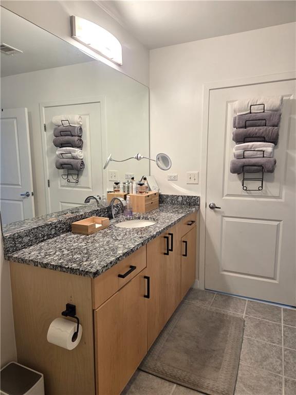 250 Pharr Road Northeast, Unit 1816 Atlanta, GA 30305 - Photo 22 of 36 a bathroom with a granite countertop sink and a mirror