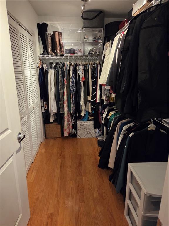 250 Pharr Road Northeast, Unit 1816 Atlanta, GA 30305 - Photo 23 of 36 a view of walk in closet with clothes and shoes