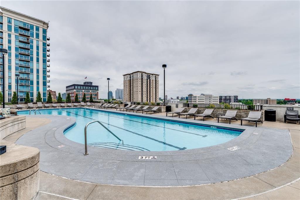 250 Pharr Road Northeast, Unit 1816 Atlanta, GA 30305 - Photo 27 of 36 a view of a swimming pool and lounge chair