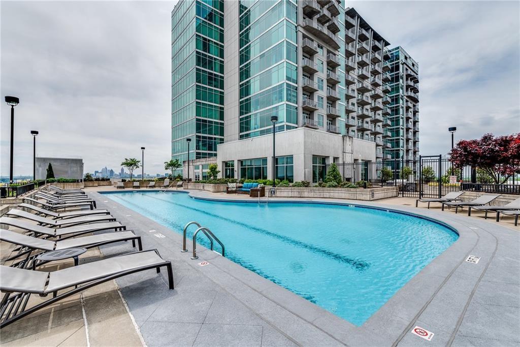 250 Pharr Road Northeast, Unit 1816 Atlanta, GA 30305 - Photo 28 of 36 a view of building with swimming pool outdoor seating