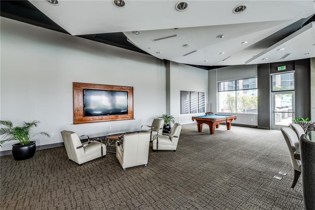 250 Pharr Road Northeast, Unit 1816 Atlanta, GA 30305 - Photo 31 of 36 a living room with furniture and a flat screen tv
