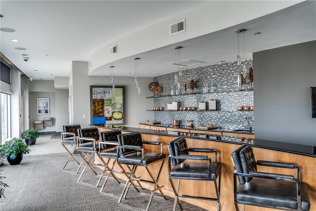 250 Pharr Road Northeast, Unit 1816 Atlanta, GA 30305 - Photo 33 of 36 a dining hall with stainless steel appliances granite countertop a table and chairs in it