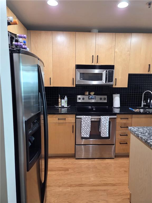250 Pharr Road Northeast, Unit 1816 Atlanta, GA 30305 - Photo 5 of 36 a kitchen with stainless steel appliances granite countertop a refrigerator a stove a sink and a microwave