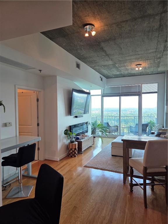 250 Pharr Road Northeast, Unit 1816 Atlanta, GA 30305 - Photo 8 of 36 a living room with furniture and a large window