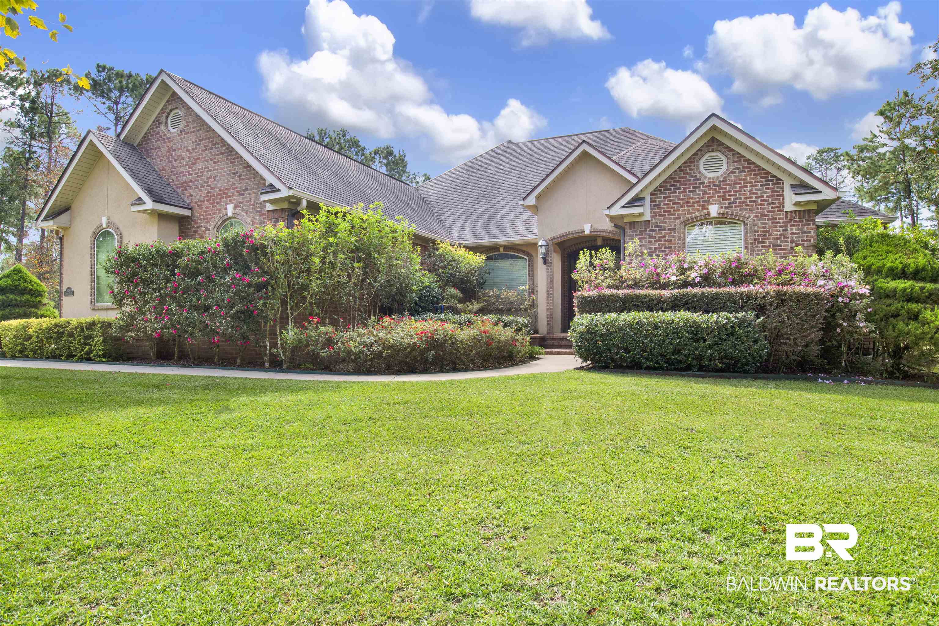 18360 Treasure Oaks Road Gulf Shores, AL 36542 - Photo 2 of 57 View of front of home featuring a front yard