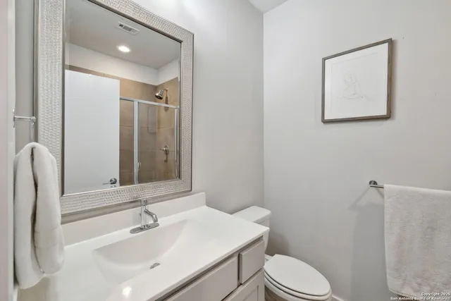 a bathroom with a sink toilet and mirror