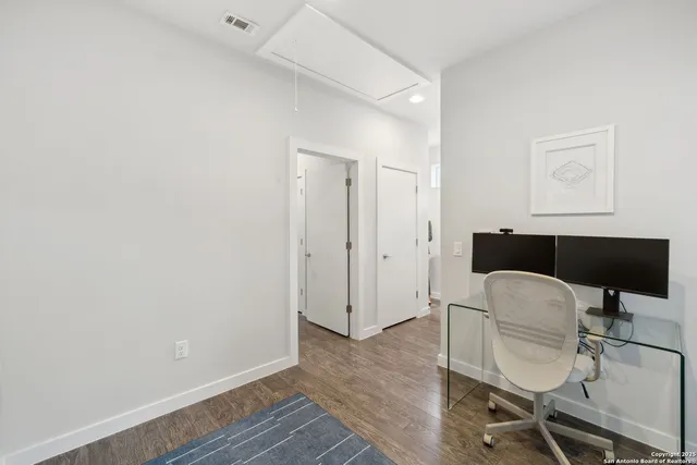a workspace with furniture and wooden floor
