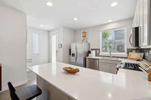 a kitchen with refrigerator and window