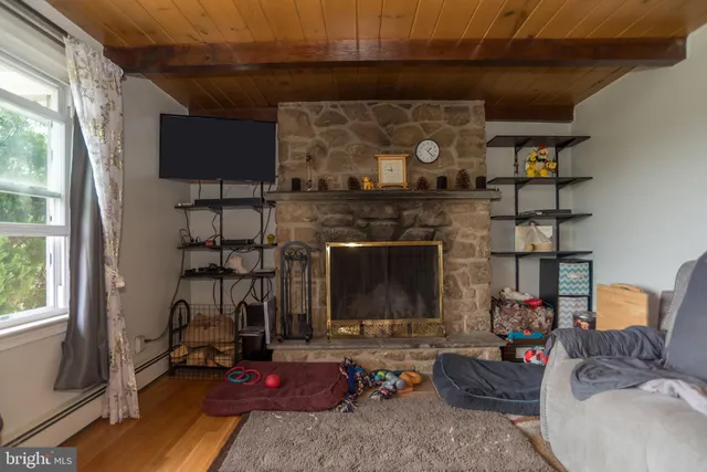 a bathroom with a refrigerator and mirror