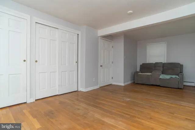 a view of a livingroom with wooden floor and a staircase
