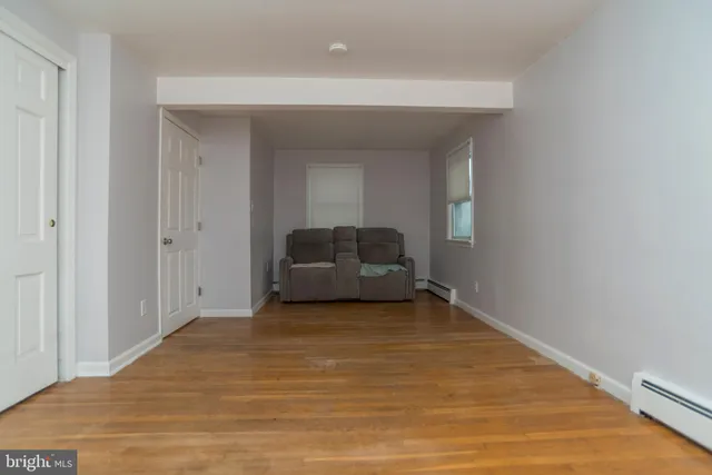 a living room with furniture a fireplace and a table