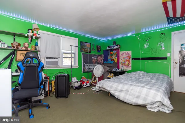 a room with lots of white furniture and a chandelier