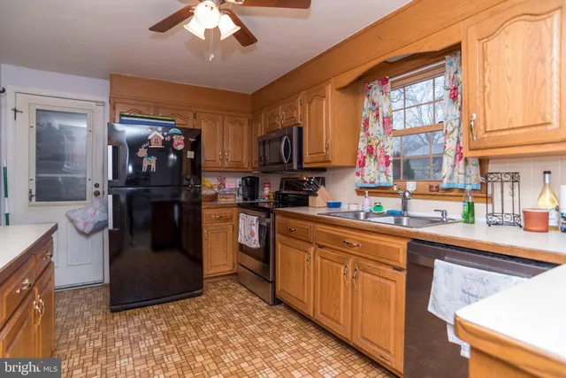 a kitchen with cabinets a sink and appliances
