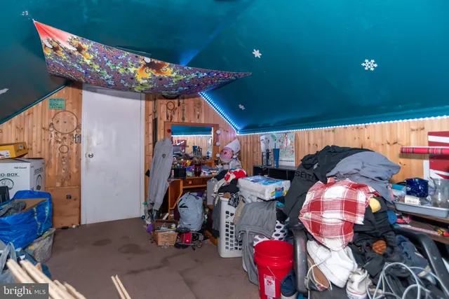 a bedroom with a bed and a wooden floor