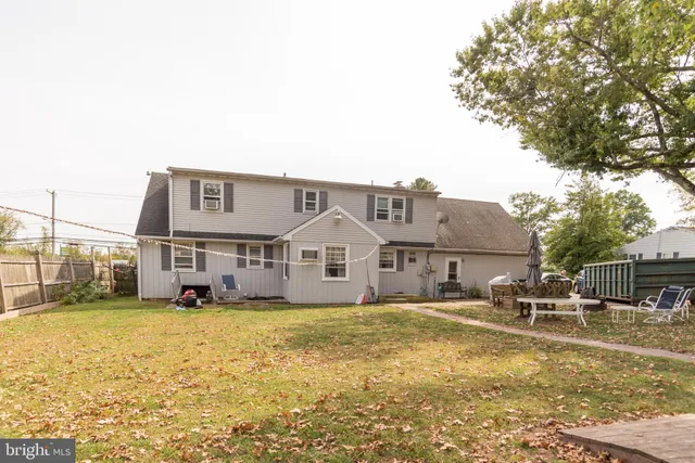 a view of a house with pool and a yard