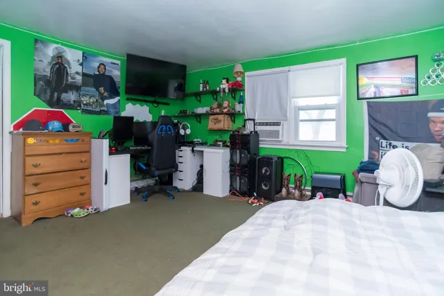 an empty room with a ceiling fan and window