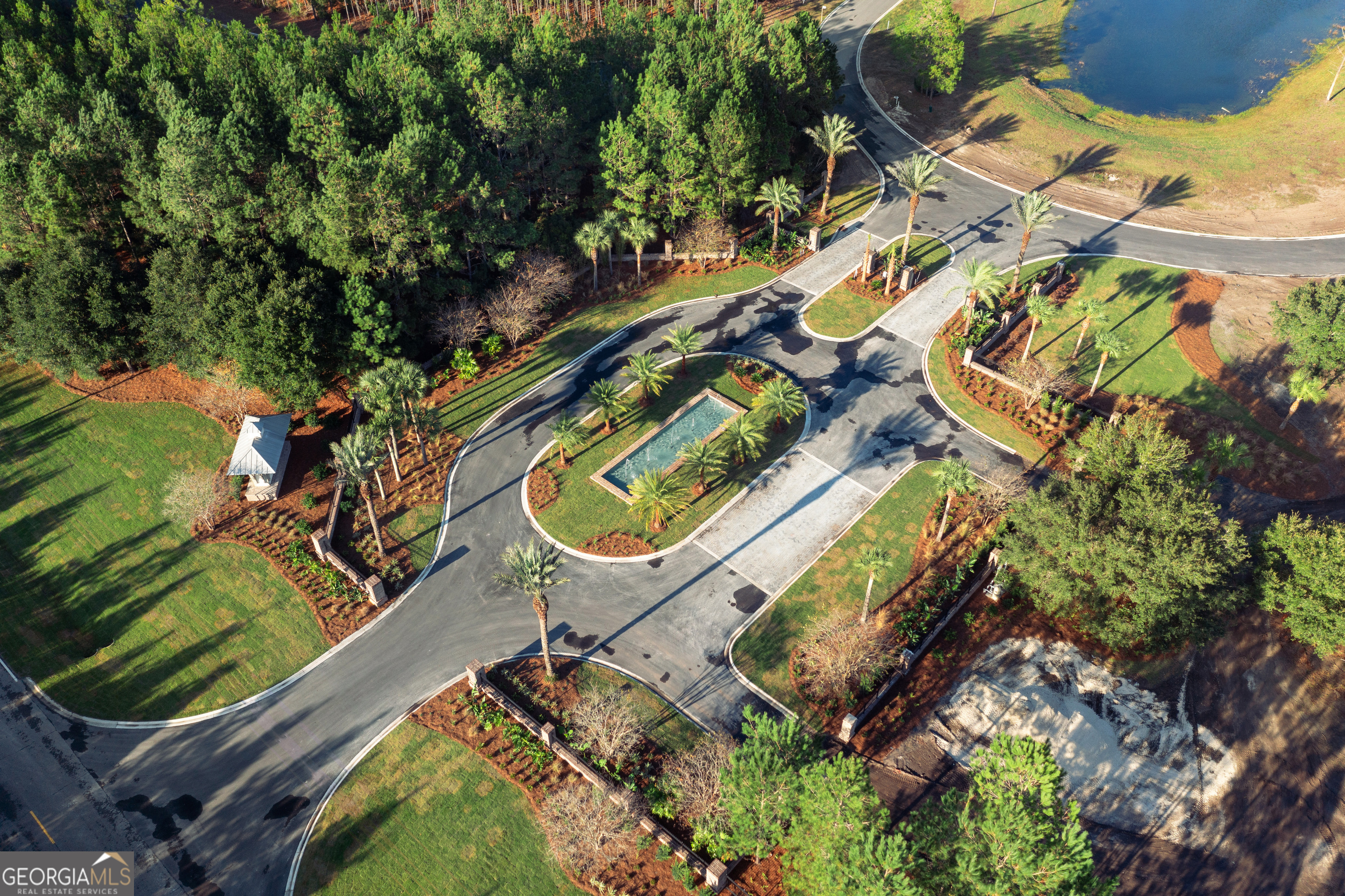 Lot 526 Beacon Pointe Parkway Waverly, GA 31565 - Photo 5 of 15 an aerial view of a house with a garden and trees