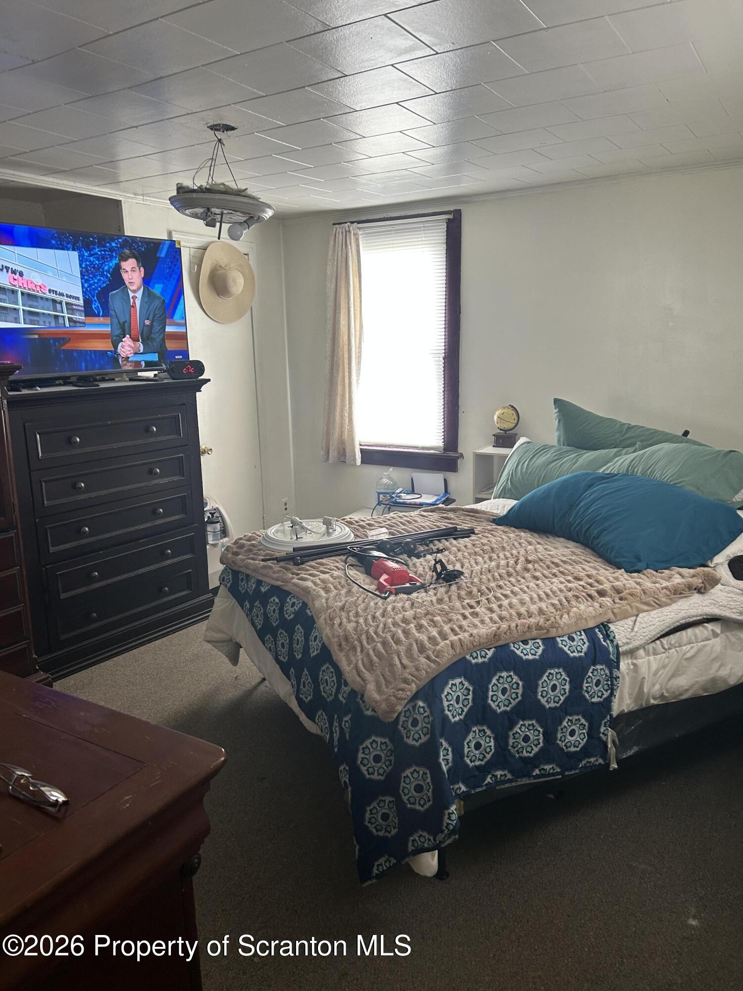 63 Shannon Street Simpson, PA 18407 - Photo 21 of 24 a bedroom with a bed and a window
