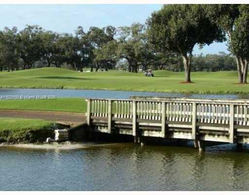 3100 West Rolling Hills Circle, Unit 101 Davie, FL 33328 - Photo 11 of 12 a view of a wooden deck with a big yard