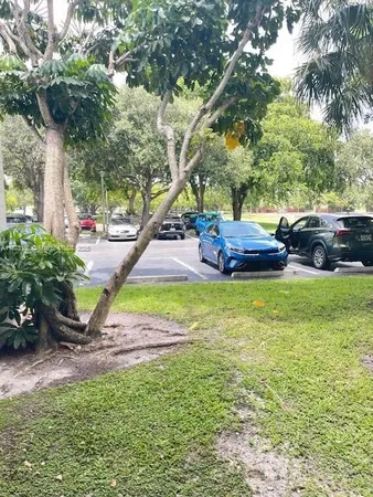 a view of yard with swimming pool and green space